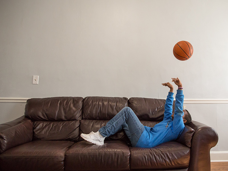 Boy on the couch with a basketball